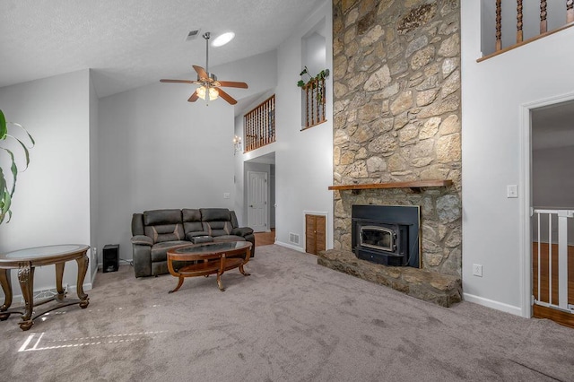 living room with carpet, ceiling fan, a towering ceiling, and a textured ceiling