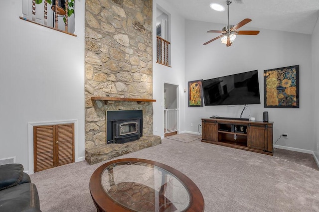 carpeted living area with baseboards, high vaulted ceiling, and a ceiling fan