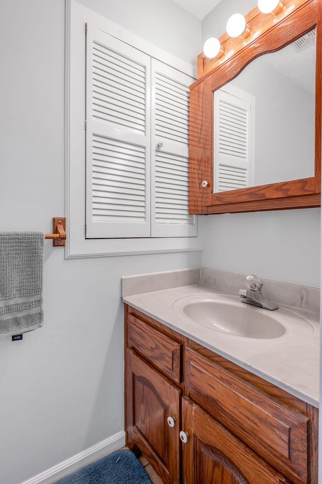 bathroom with baseboards and vanity