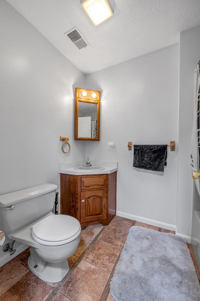 bathroom with visible vents, toilet, a textured ceiling, baseboards, and vanity