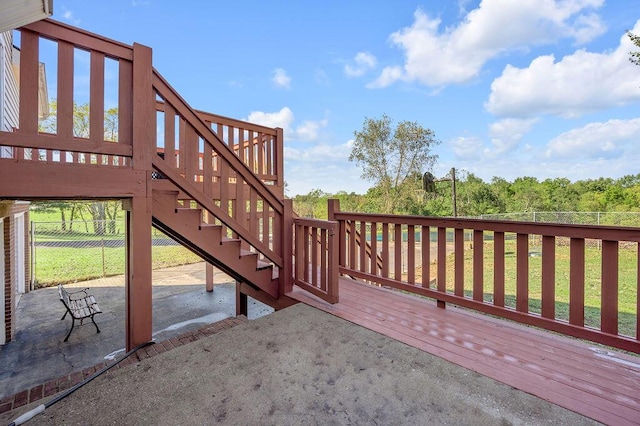 wooden terrace with stairs, a patio area, and fence