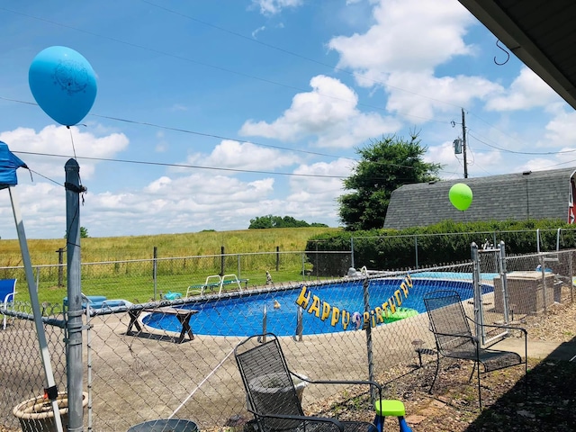 view of swimming pool with a fenced in pool and fence