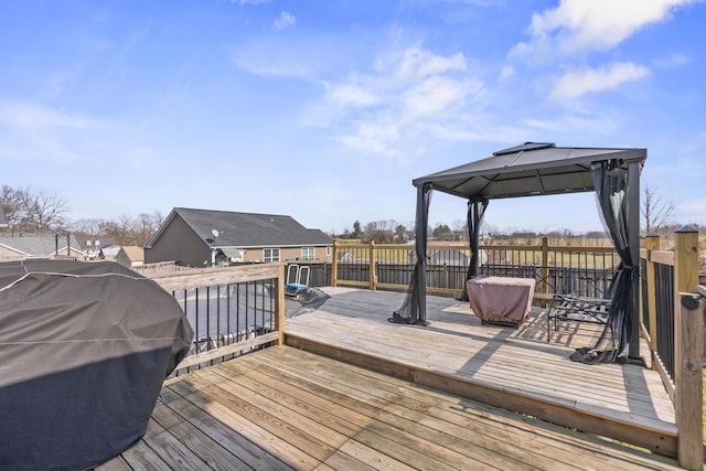 wooden deck with a gazebo and grilling area