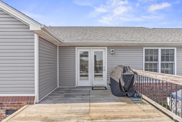 wooden deck featuring a grill