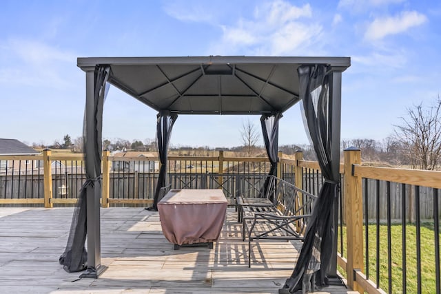 wooden deck with a gazebo and fence