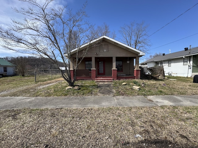 bungalow-style house with a porch and brick siding