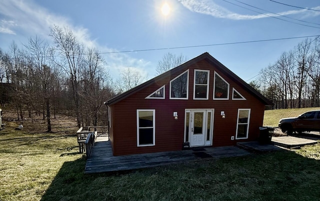 back of property with a yard and a deck