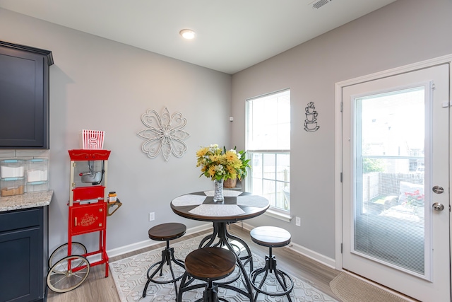 dining space with visible vents, baseboards, and light wood-style floors