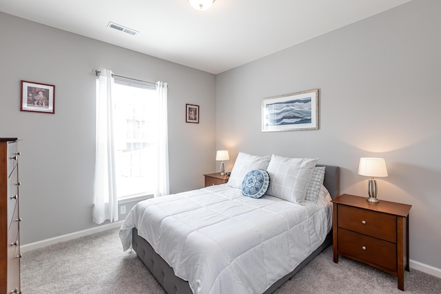 carpeted bedroom with visible vents and baseboards