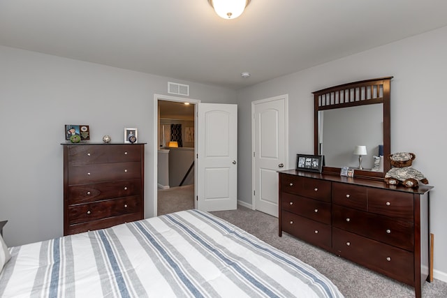 carpeted bedroom with visible vents and baseboards