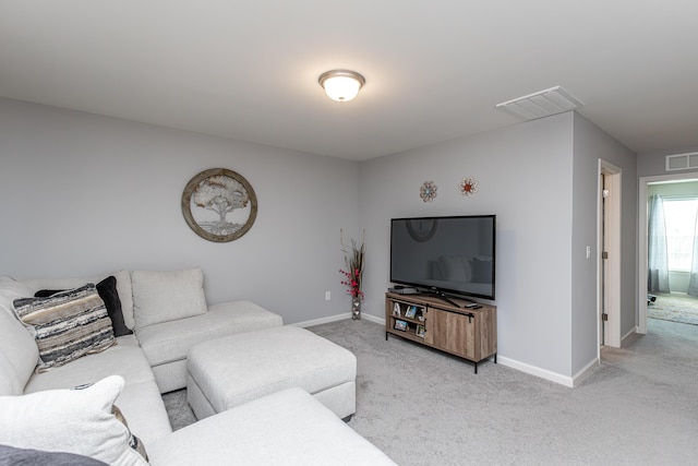 living area with visible vents, light carpet, and baseboards