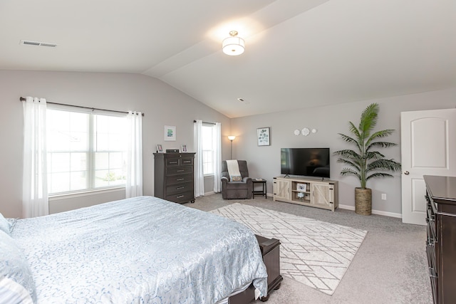 bedroom featuring light carpet, visible vents, baseboards, and lofted ceiling