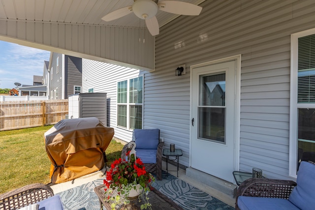 view of patio / terrace with grilling area, ceiling fan, and fence