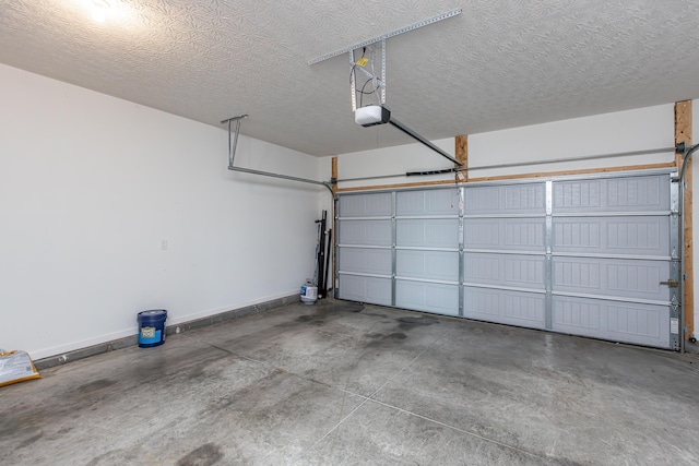 garage with a garage door opener and baseboards