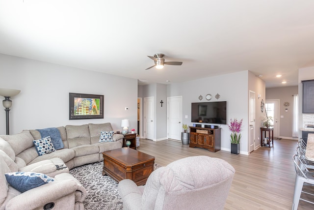 living room featuring recessed lighting, baseboards, a ceiling fan, and light wood finished floors