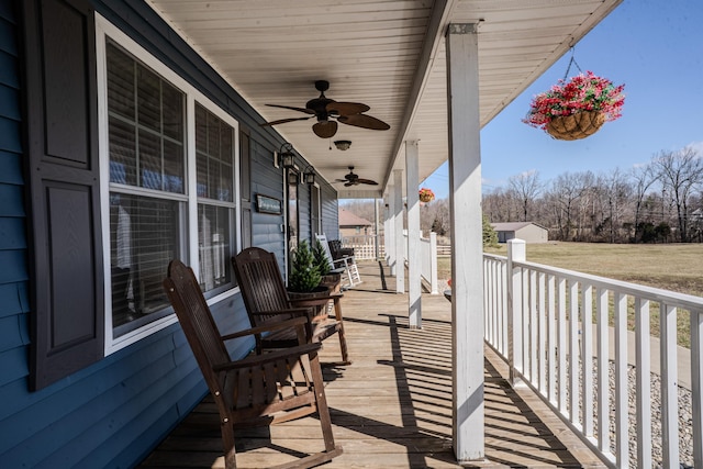 deck featuring covered porch and ceiling fan