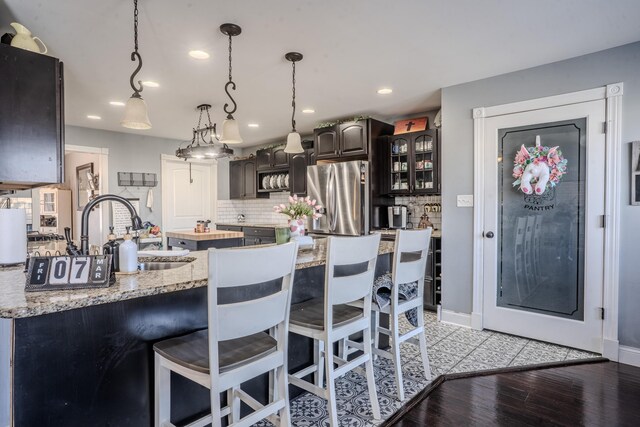 1204 Meadow Brook Dr, Lawrenceburg, KY 40342 - kitchen with decorative backsplash, stainless steel fridge, and a breakfast bar