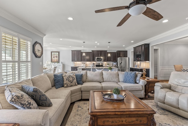 living room featuring recessed lighting, crown molding, and a ceiling fan