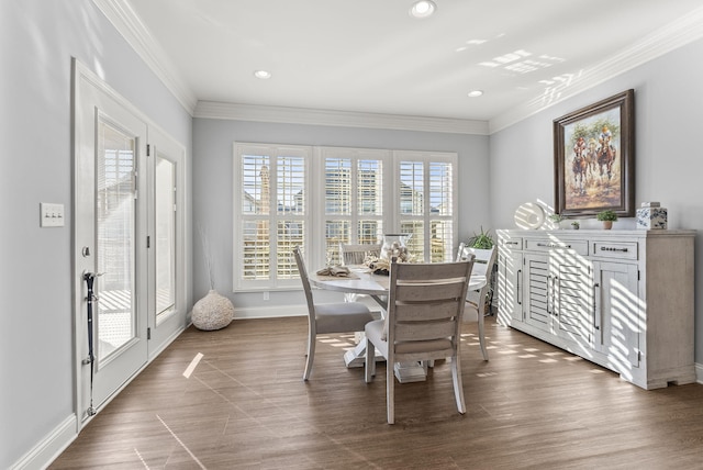 dining space featuring dark wood-style floors, plenty of natural light, and crown molding