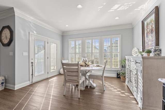 dining room with recessed lighting, crown molding, baseboards, and wood finished floors