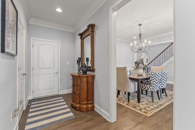 interior space with baseboards, ornamental molding, recessed lighting, an inviting chandelier, and wood finished floors