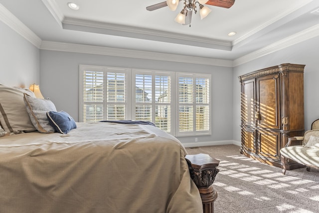 bedroom with a raised ceiling, multiple windows, and carpet