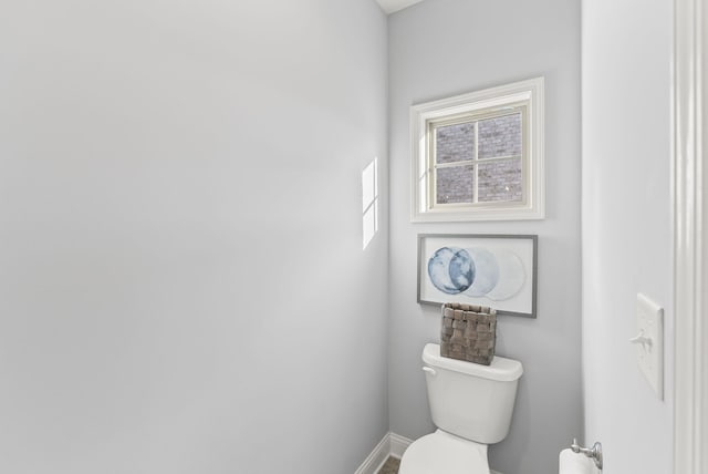 bathroom with baseboards and toilet