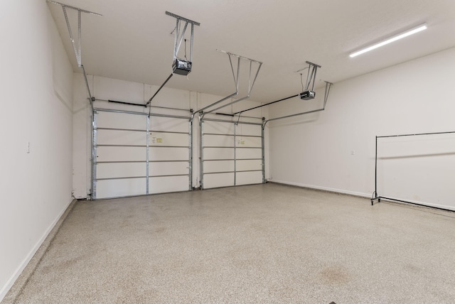 garage with a garage door opener and baseboards