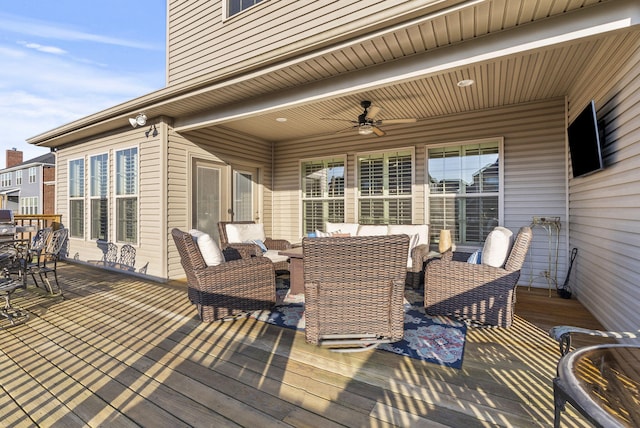 wooden terrace with an outdoor hangout area and ceiling fan