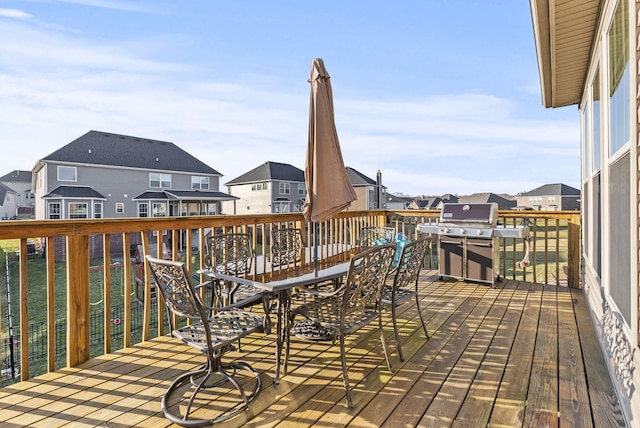 wooden terrace with grilling area and a residential view