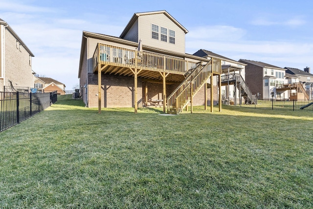 back of property featuring stairway, a lawn, a fenced backyard, and a deck