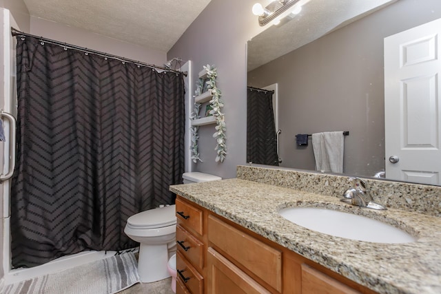 full bathroom with vanity, curtained shower, toilet, and a textured ceiling