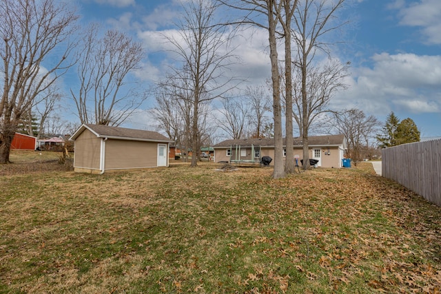 view of yard with an outdoor structure and fence