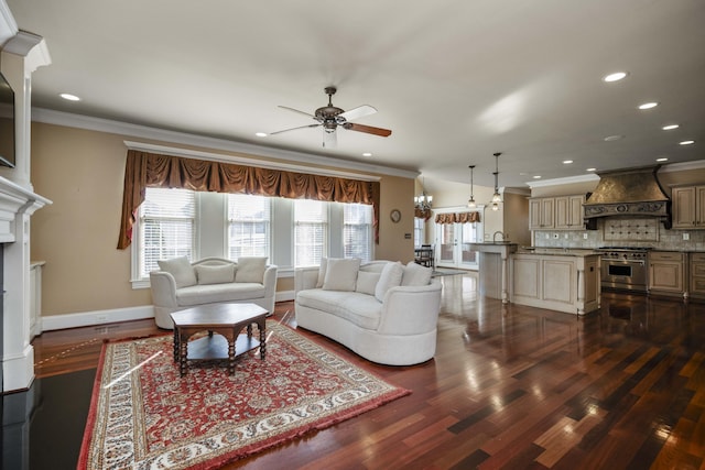 living area featuring a fireplace, dark wood-type flooring, baseboards, and ornamental molding