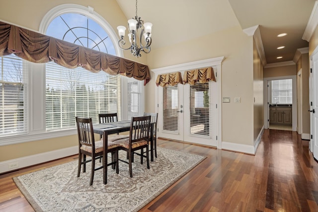 dining space featuring recessed lighting, a notable chandelier, wood finished floors, and baseboards