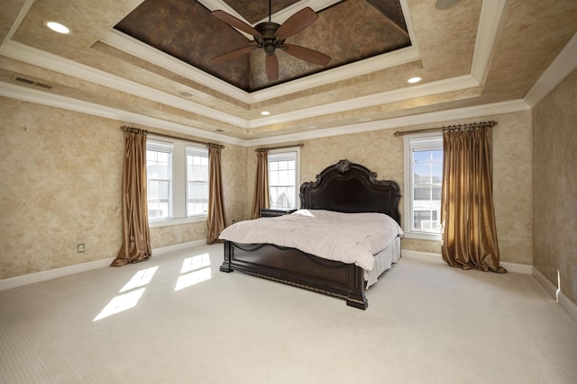 bedroom with baseboards, visible vents, a tray ceiling, ornamental molding, and light colored carpet