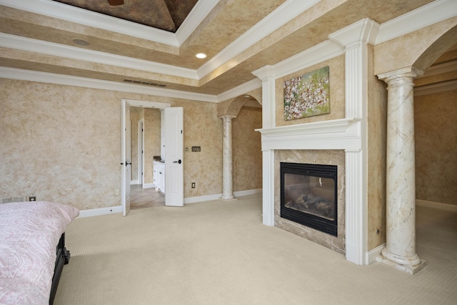 unfurnished bedroom with a high end fireplace, carpet floors, ornamental molding, decorative columns, and arched walkways