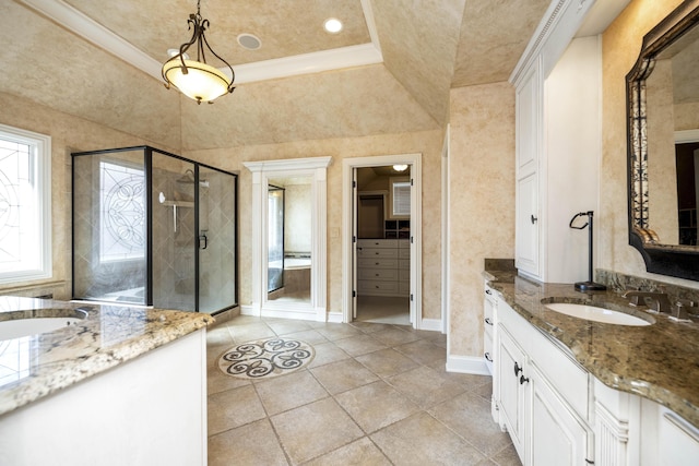 bathroom with two vanities, a stall shower, a sink, crown molding, and a spacious closet