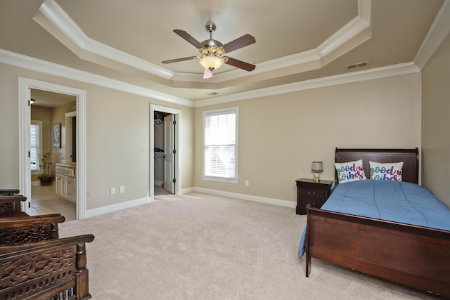 bedroom with visible vents, crown molding, baseboards, light carpet, and a raised ceiling