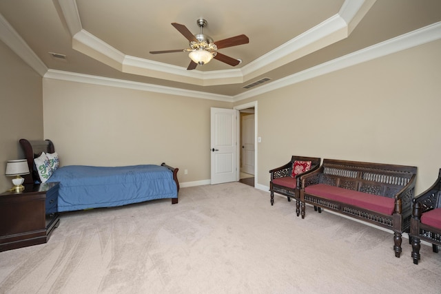 carpeted bedroom with a tray ceiling, baseboards, visible vents, and ornamental molding