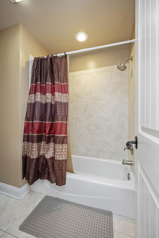 full bath with tile patterned flooring, baseboards, and shower / tub combo with curtain