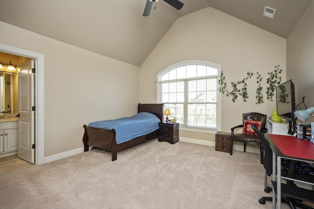 bedroom with lofted ceiling, light colored carpet, visible vents, and ensuite bathroom