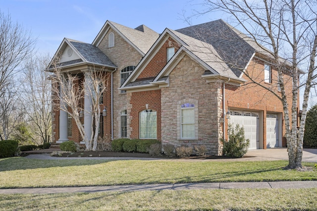 view of front of home with brick siding, a garage, driveway, and a front yard