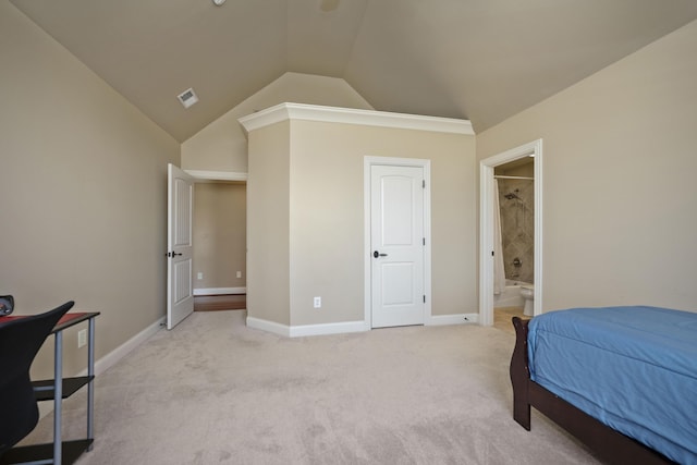 bedroom with visible vents, connected bathroom, baseboards, vaulted ceiling, and light carpet