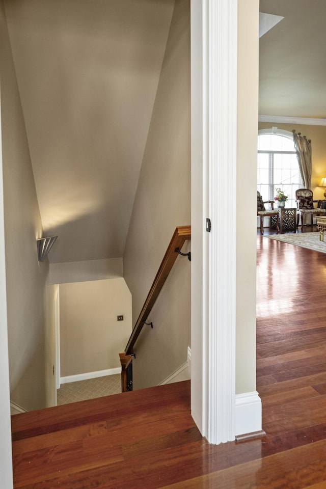 stairs featuring wood finished floors and baseboards