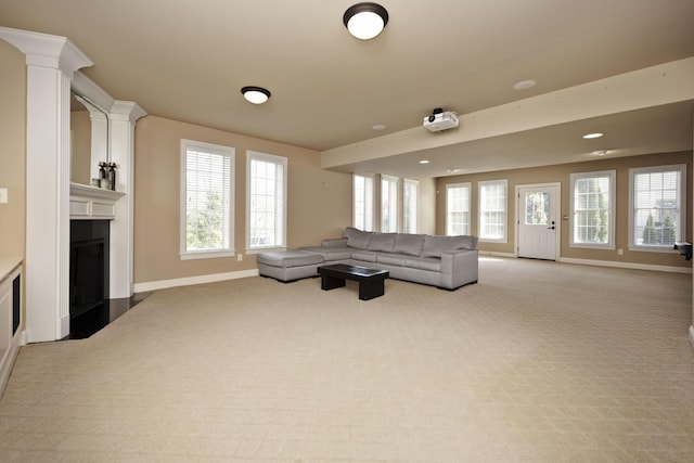 living room with recessed lighting, baseboards, light colored carpet, and a fireplace