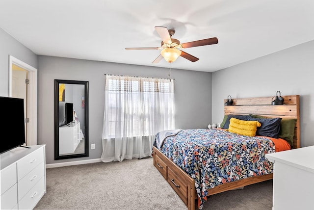 bedroom featuring ceiling fan, baseboards, and light carpet