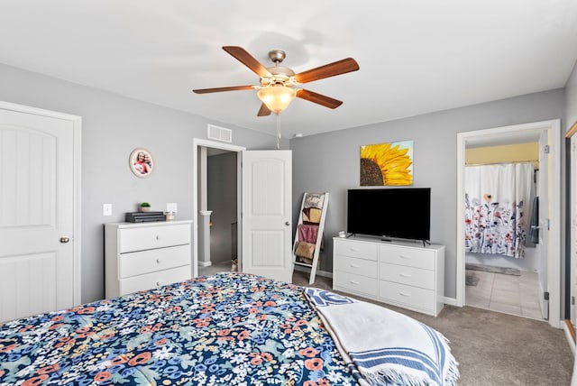 bedroom with visible vents, carpet floors, connected bathroom, and a ceiling fan