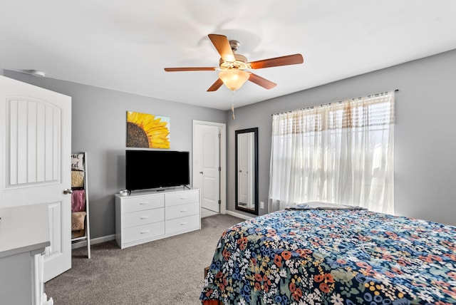 carpeted bedroom with baseboards and a ceiling fan