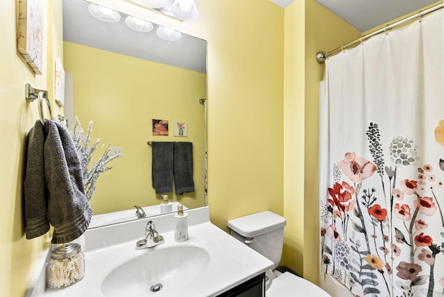 bathroom featuring a shower with curtain, toilet, and vanity